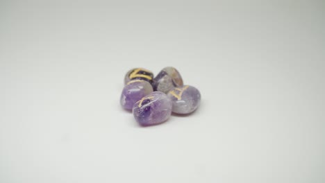 a beautiful purple colored gem stones with yellow mark on the top rotating slowly - close up shot