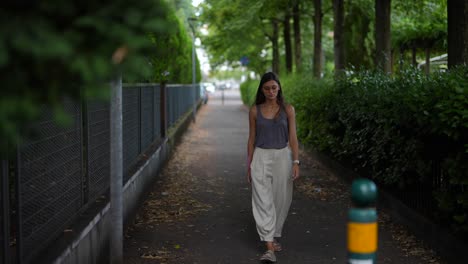 woman walking down a city alley