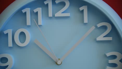 blue wall clock on red background