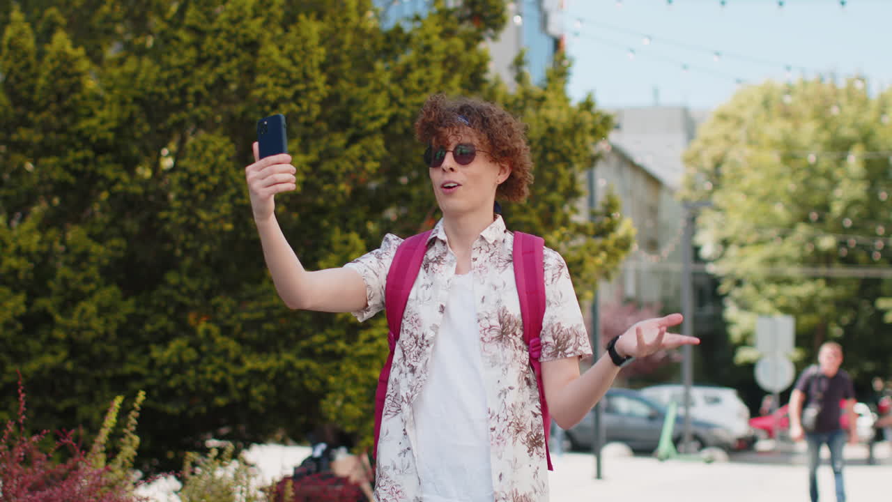 Tourist man blogger taking selfie on smartphone communicating video call online with subscribers
