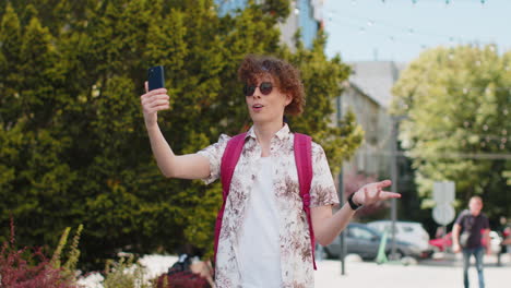 tourist man blogger taking selfie on smartphone communicating video call online with subscribers