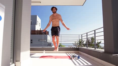 man exercising with skipping ropes