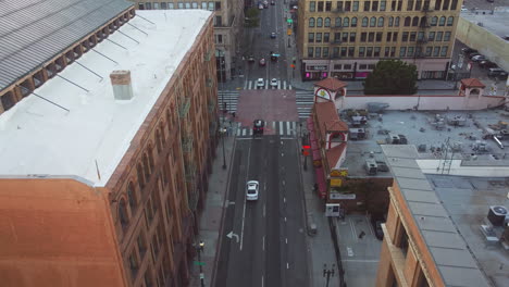 Traffic-on-Broadway-Downtown-District-Highway-Los-Angeles,-Drone-Shot-Flying-Over