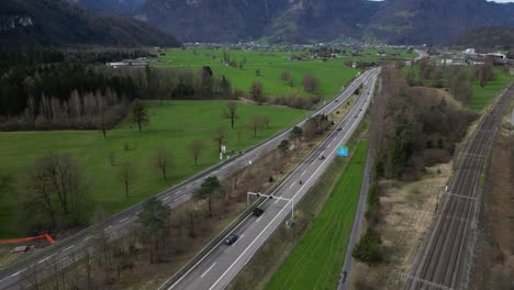 rail train tracks near dual carriageway motorway transport system, aerial