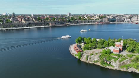 Aerial-view-of-Kastellet-Building-and-sightseeing-tour-boats-outside-Djurgarden-Island-with-Stockholm-in-background