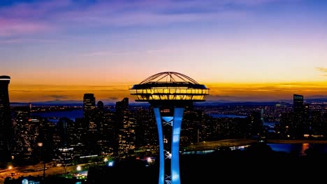 vibrant sunset illuminates the seattle skyline, highlighting the iconic space needle against a colorful evening sky