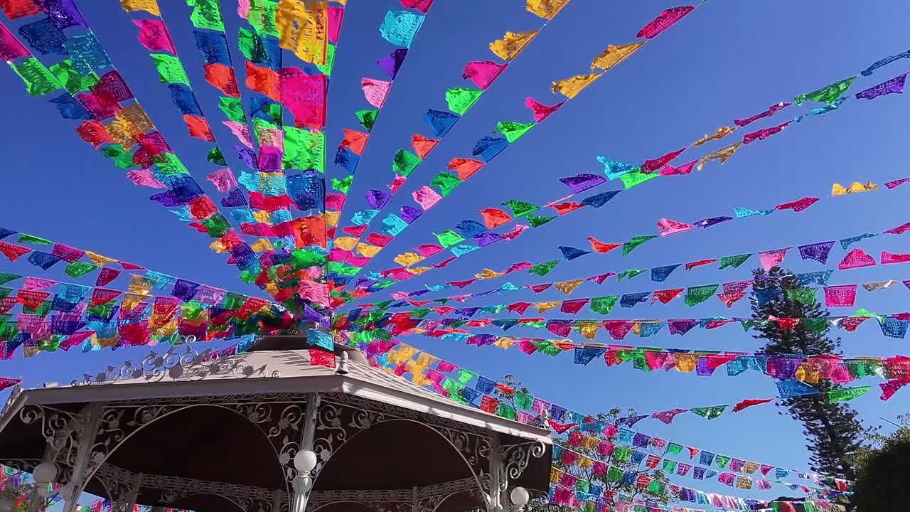 Colorful decorations in downtown Jiutepec during the day in Morelos, Mexico, pull back shot