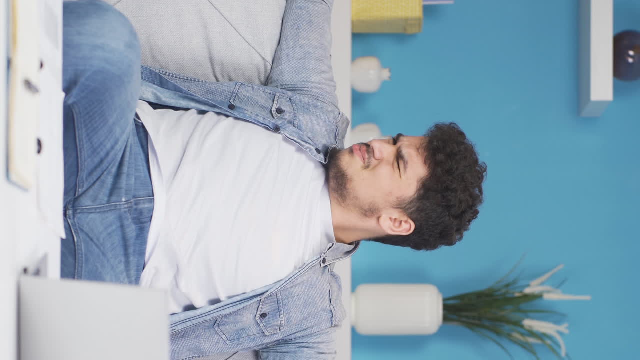 Vertical video of The man who smells bad odor is disturbed and disgusted.