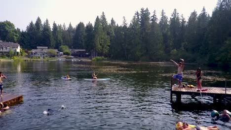 people enjoying the summer outdoors doing a variety of water activities at the mountain lake in washington, usa - medium shot