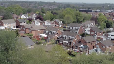 Quiet-British-homes-and-gardens-residential-suburban-property-aerial-view-orbit-left-zoom-in