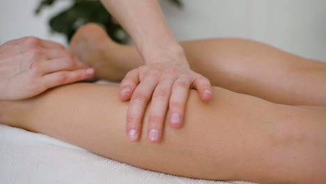 Woman-receiving-a-leg-massage