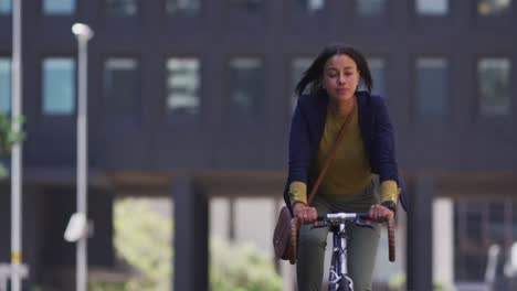 African-american-woman-riding-bicycle-in-street