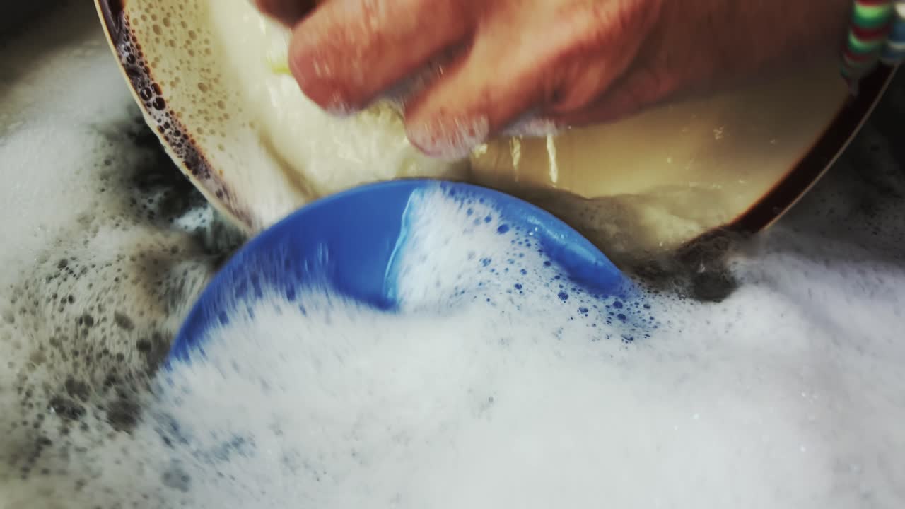 Domestic Person Washing Dishes in Soapy detergent water Slow Motion
