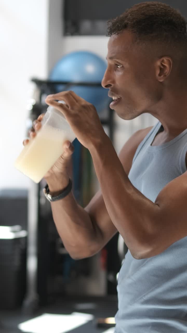 Man drinking protein shake in the gym