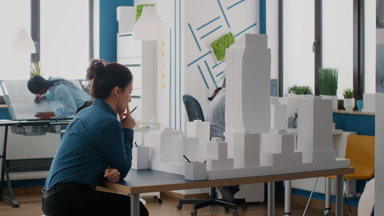 Architects collaborating on a building model