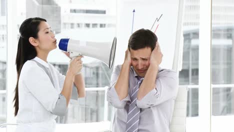 Asian-businesswoman-shouting-through-a-megaphone