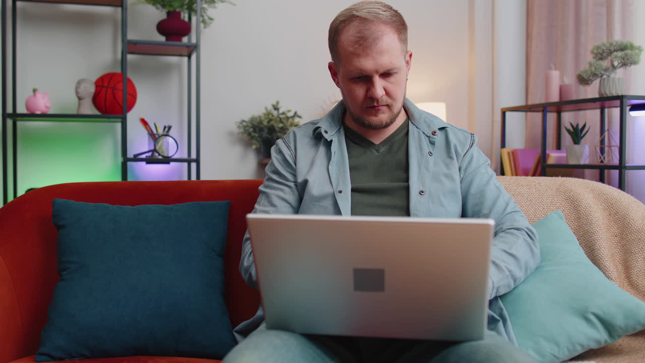 Adult man at home office use laptop pc typing browsing say wow yes found out great big win celebrate