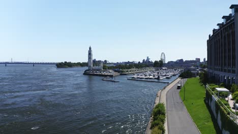 a serene shot of the lighthouse near montreal's old port, standing tall against the river and cityscape. a symbol of guidance and tranquility, perfect for capturing the charm of the waterfront.