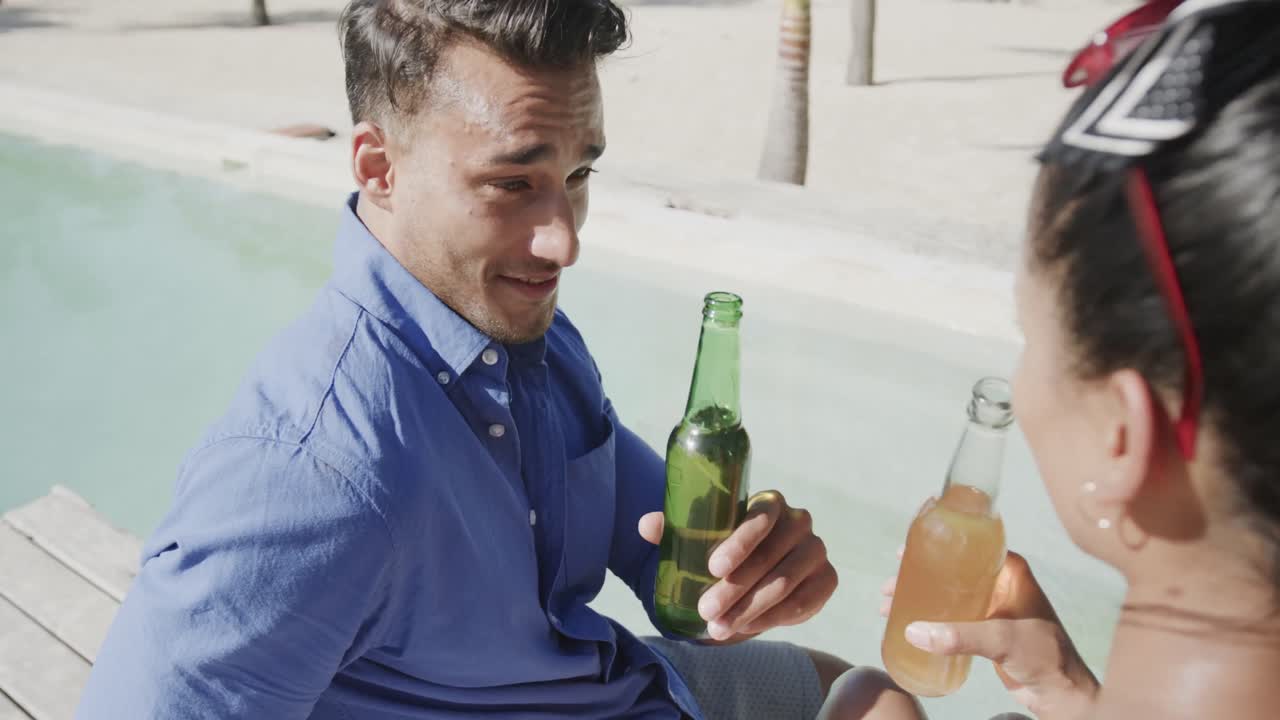 다양한 행복한 커플이 이야기하고 바 ⁇ 가에서 맥주를 마시고 수영장  ⁇ 에서 태양 데크, 슬로우 모션