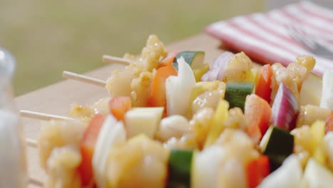 four chicken and vegetable kabobs on cutting board