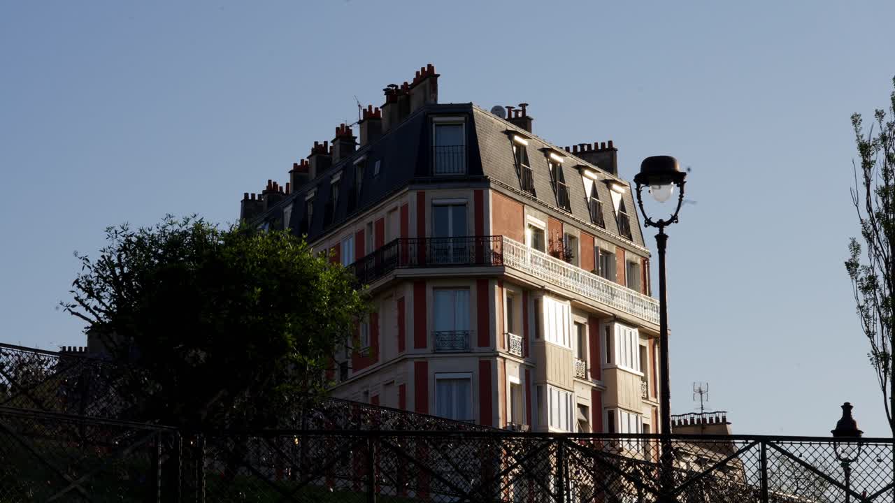 Wide angle view of a Parisian building from Montmartre during sunset summer.