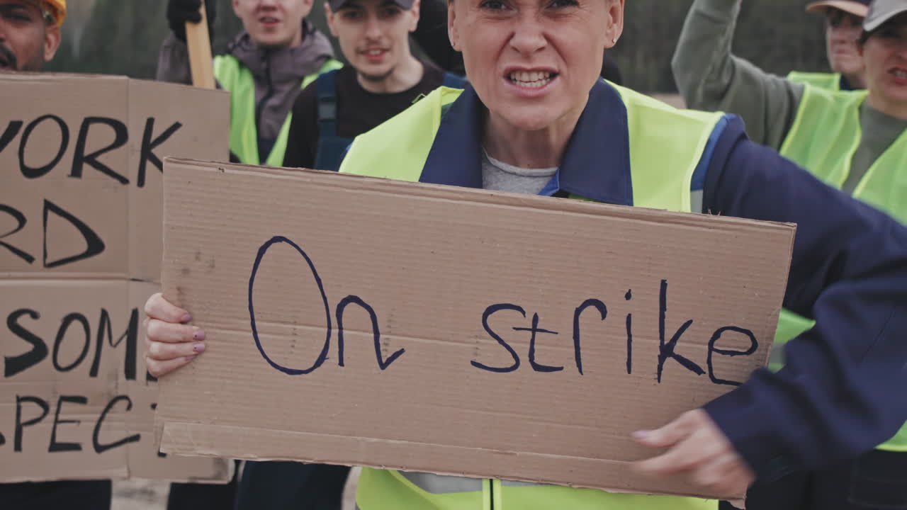 Angry Woman and Crowd of Workers Protesting