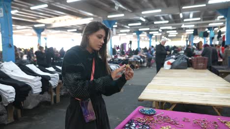 woman shopping for jewelry at an indoor market