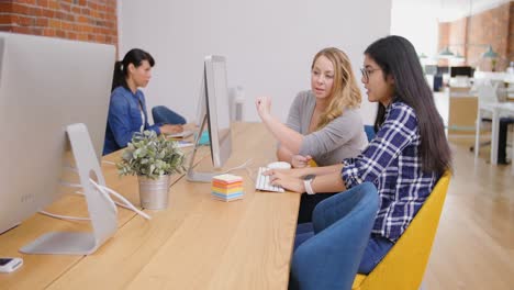 businesswomen discussing over computer 4k