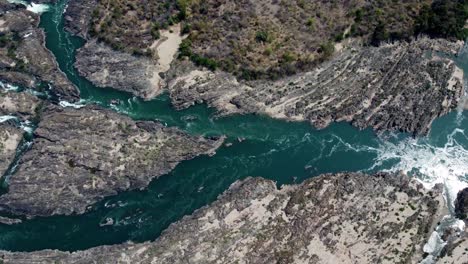 A-little-part-of-the-famous-Khon-Phapheng-Falls-from-above,-the-colours-of-the-water-in-between-the-rocks-and-trees-make-a-very-special-sight-from-above