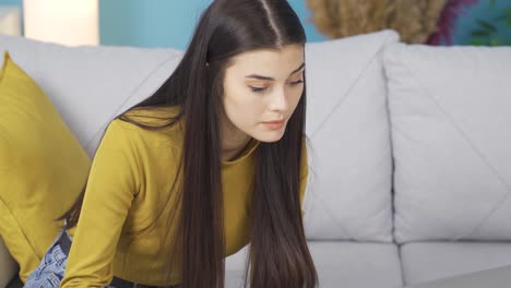 beautiful young entrepreneur woman working from home happily working from laptop. business expert.