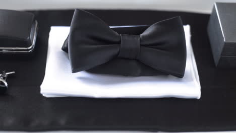 elegant black bow tie with wedding rings