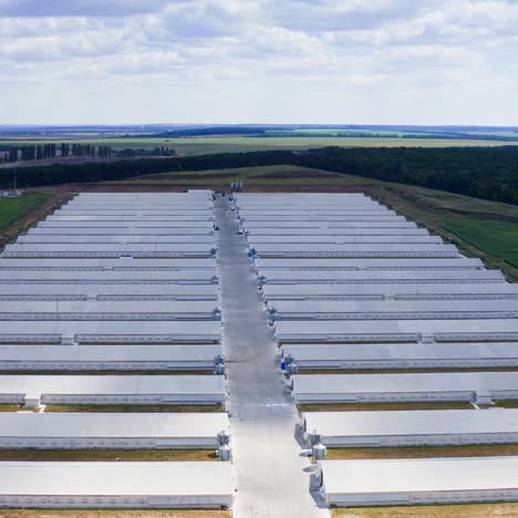 farm buildings on nature landscape. white warehouses on green field in the countryside. modern agriculture. aerial view