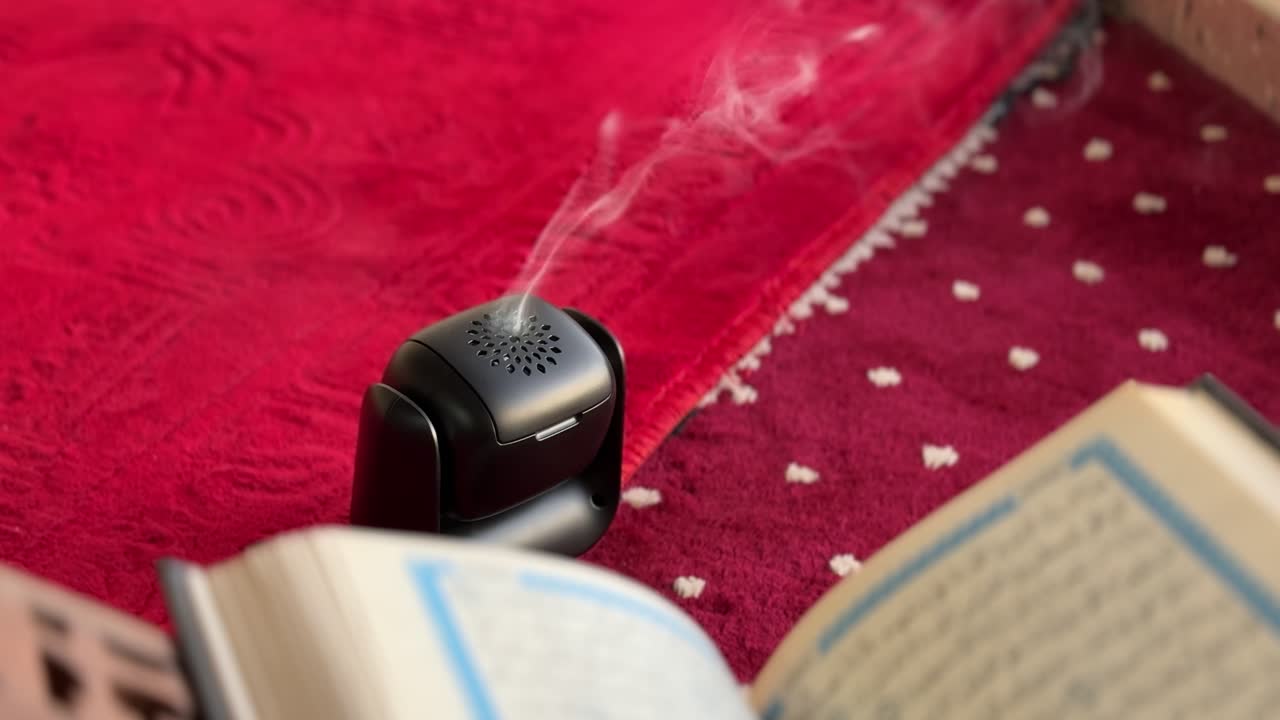 Peaceful 4K scene of Quran reading with incense smoke gently rising over a red prayer rug. Ideal for Islamic content, Ramadan themes, or spiritual ambiance visuals.