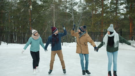 friends ice skating in winter park