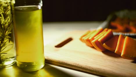 Close-up-olive-oil-bottle-on-table.-Healthy-food.-Pumpkin-pieces