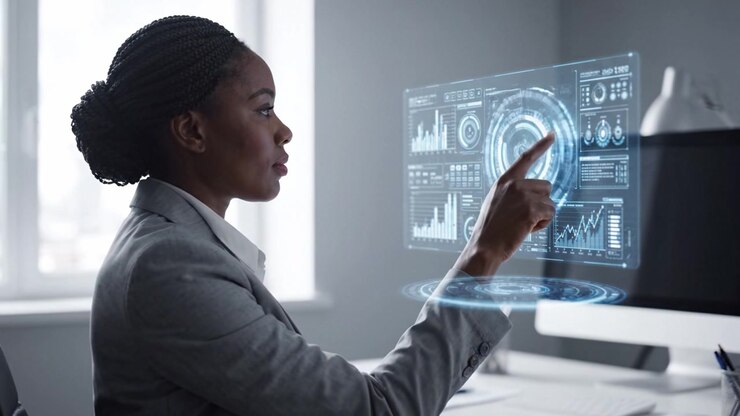 Focused professional woman in a modern office analyzing interactive digital data on a futuristic display, showcasing dedication and expertise in her field.