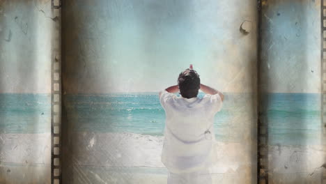 person standing on beach, looking at ocean, with vintage film animation overlay