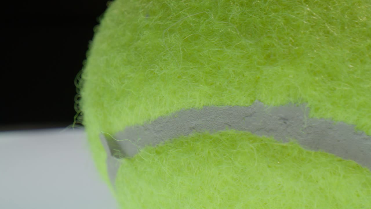 Tennis ball with macro video close up moving in a circle.