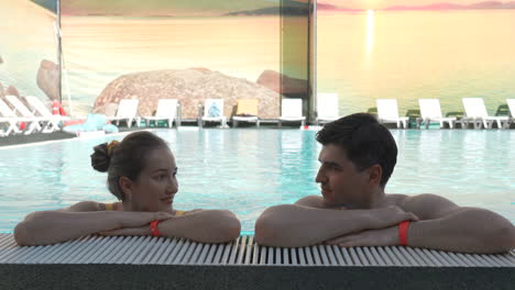 couple relaxing by the pool