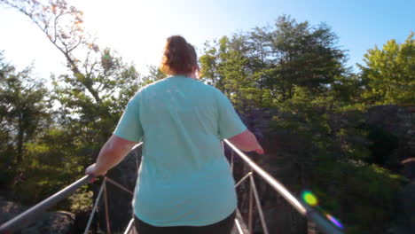 Hiker-girl-crossing-a-hanging-bridge