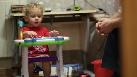 un niño jugando al piano de juguete.