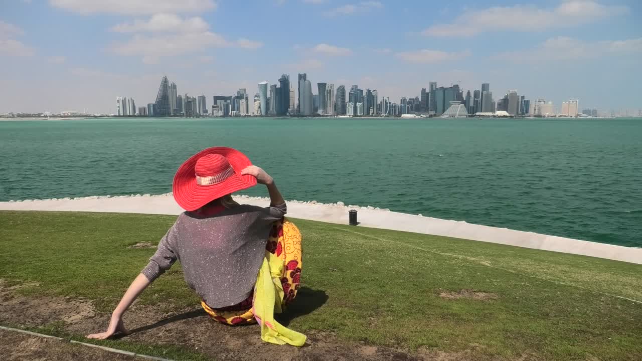 Woman looking Doha Skyline