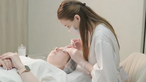 cosmetologist performing facial injection procedure