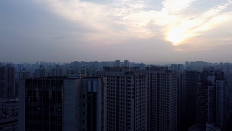 cinematic aerial ascent reveals the city plaza, skyscrapers, and breathtaking sunset sky in chongqing, china