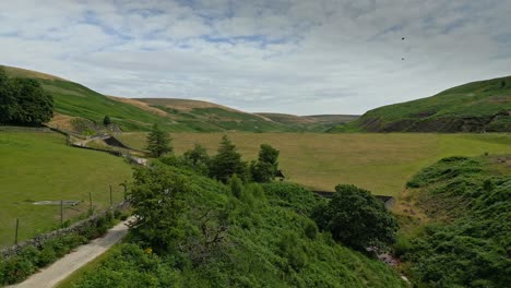 Aerial-drone-video-footage-of-a-footpath-and-reservoir-dam-wall-showing-overflow-structures