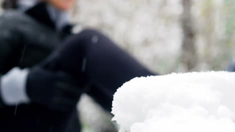 beautiful woman exercising during snowfall