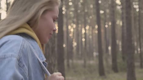 portrait of young woman walking in the forest