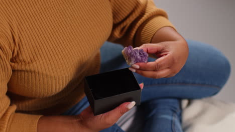 mujer sosteniendo una caja de joyas con ametista