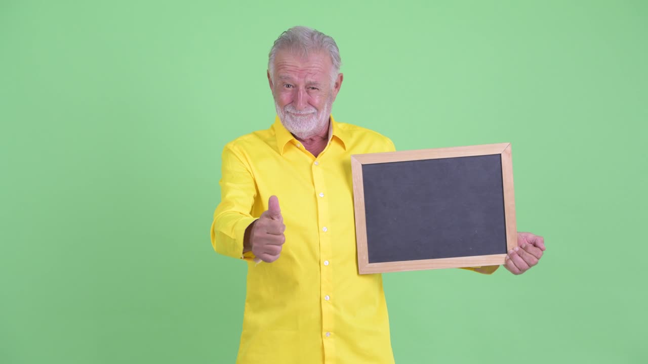 Happy handsome senior bearded businessman