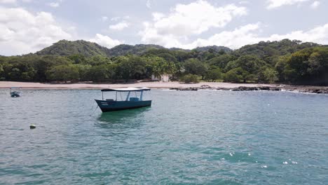 Close-Flight-Past-An-Empty-Fishing-Boat-Off-The-Coast-Of-Playa-Real,-Guanacaste-Province